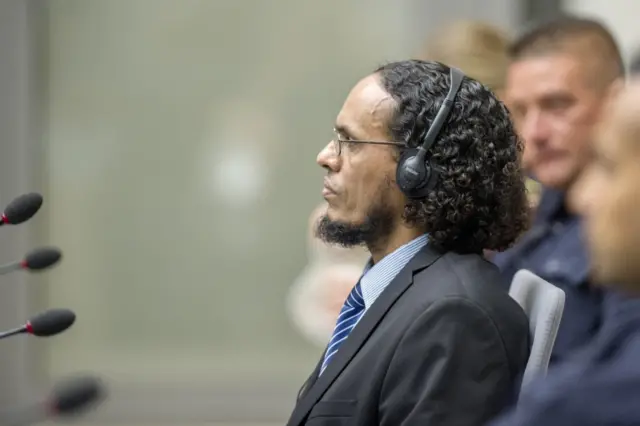 Ahmad Al Faqi Al Mahdi sits as he appears at the International Criminal Court in The Hague, Netherlands, Monday, Aug. 22, 2016