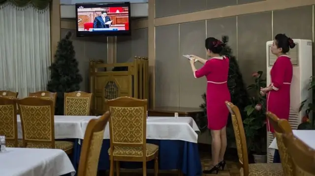 Women using TV in North Korea