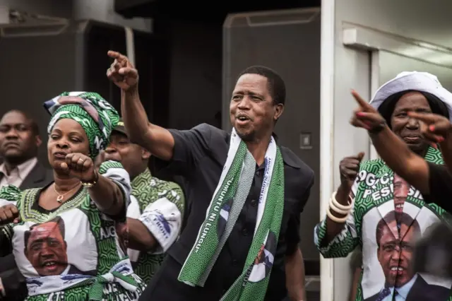 This file photo taken on August 10, 2016 in Lusaka shows Zambian Ruling party Patriotic Front presidential candidate and incumbent Zambian President Edward Lungu (C) dancing and gesturing before delivering a speech during his presidential campaign closing rally.