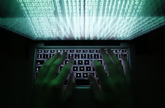 Person typing on a computer keyboard