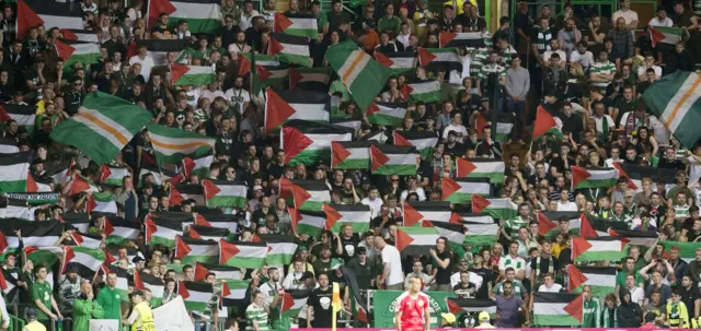 Celtic fans hold up Palestinian flags during the match against Hapoel Beer Sheva