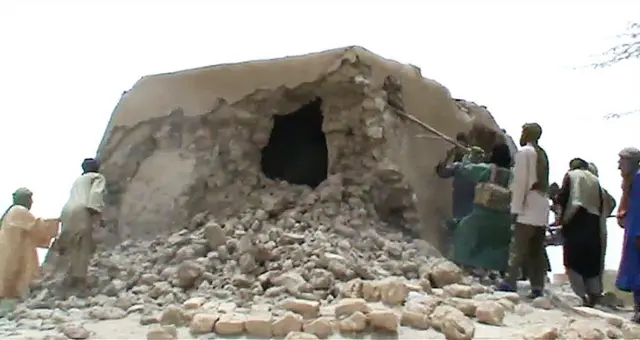 Islamist militants destroying an ancient shrine in Timbuktu in 2012