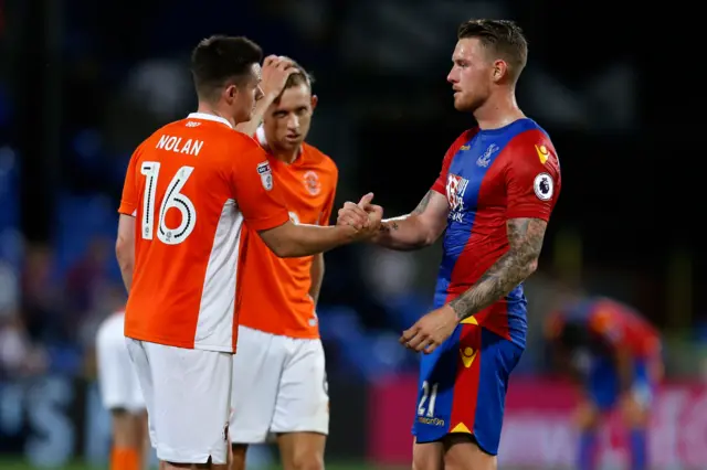 Palace's Wickham shakes hands with Eddie Nolan of Blackpool