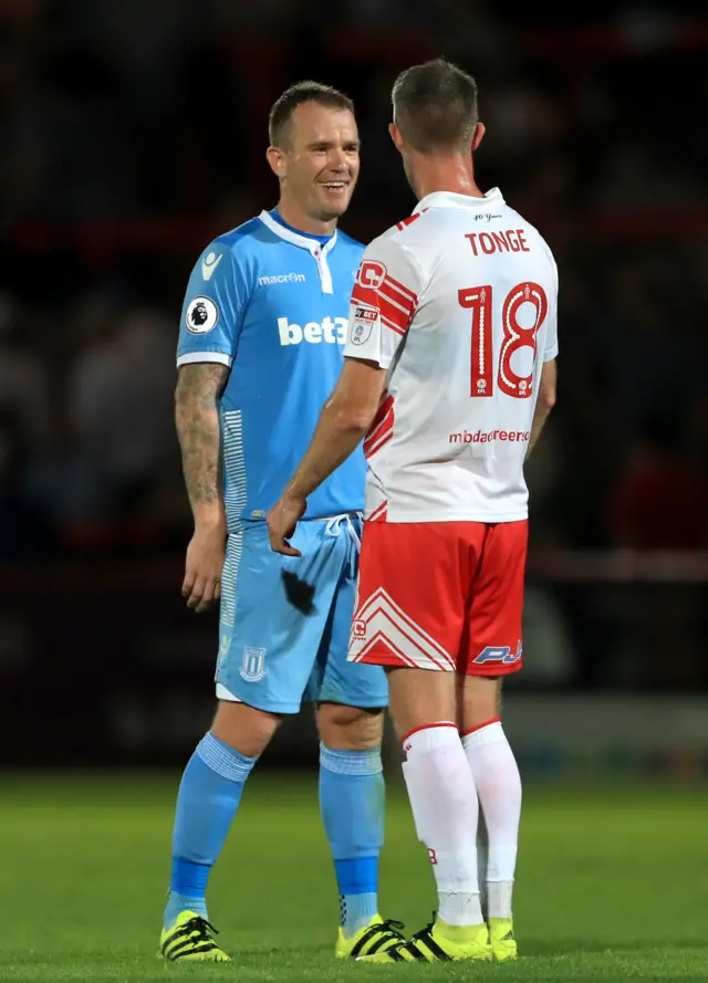 Stoke's Whelan chats with Stevenage's Tonge