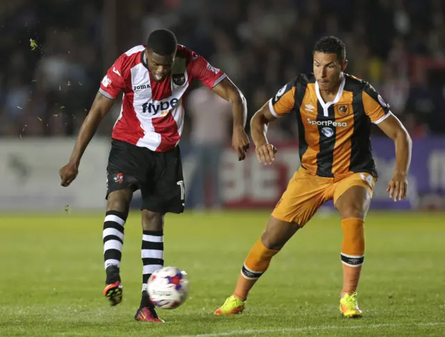 Joel Grant of Exeter City in action with Jake Livermore of Hull City