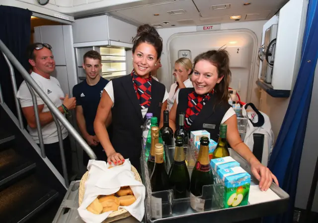 Sam Quek and Sutton Coldfield's Laura Unsworth of the gold medal-winning Great Britain women's hockey team dressed up as cabin crew during the Team GB flight back from Rio on their British Airways flight