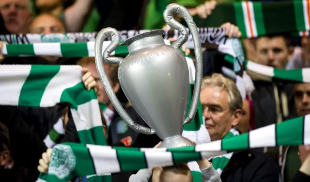 Celtic fans hold aloft an inflatable Champions League trophy