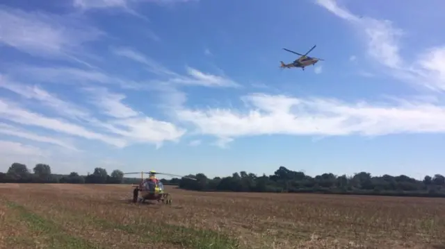 Two air ambulances landing in field