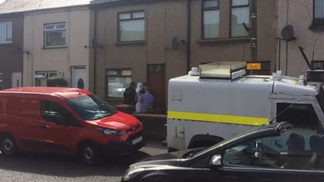 At least two properties on the Old Glenarm Road in Larne, County Antrim, are being searched in connection with the terrorism investigation