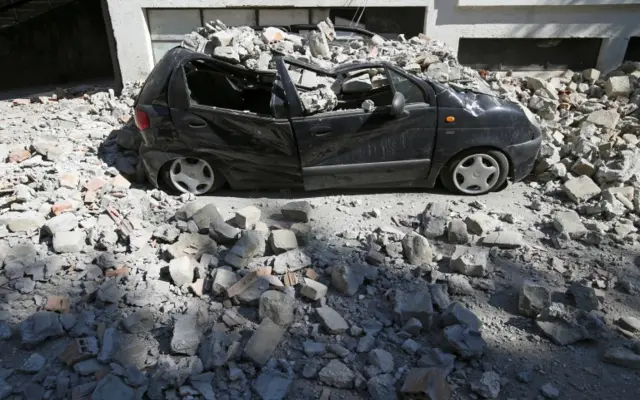 A destroyed car in Amatrice