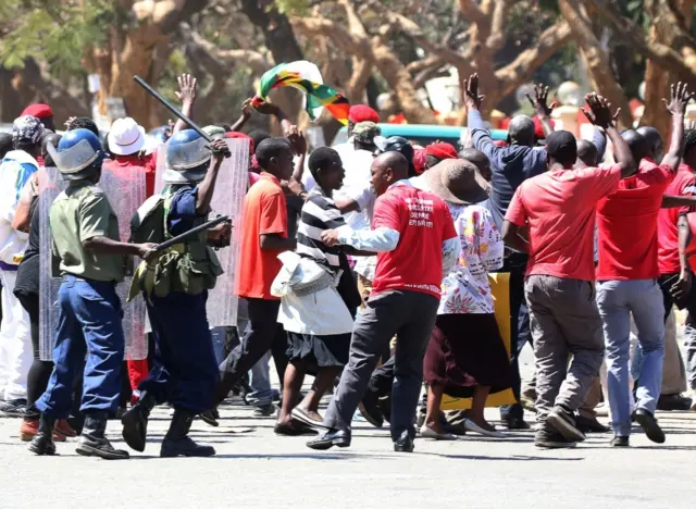 Anti-riot police use batons to disperse demonstrators during a protest by opposition youths against alleged brutality by security agents in the capital Harare, Zimbabwe August 24, 2016.