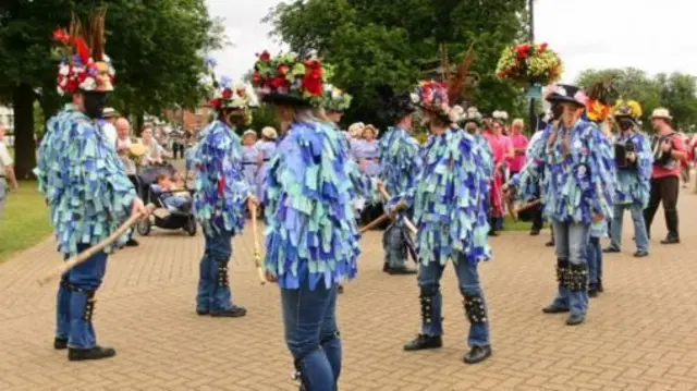 Morris dancers with black faces