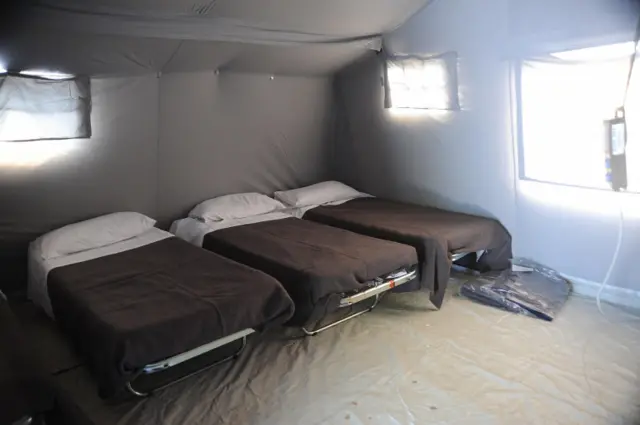 Beds inside a tent of a temporary camp in Pescara del Tronto