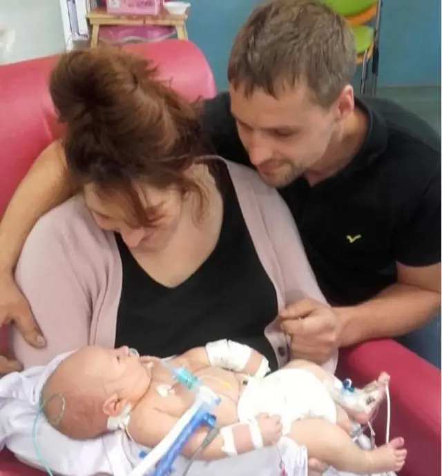 Mum and dad Gemma and Sam Fletcher with baby George