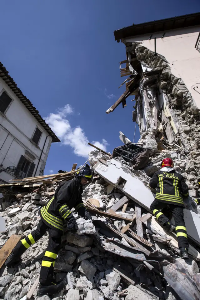 Firefighters continue digging through the rubble of collapsed buildings, in Arquata, central Italy, a day after a deadly earthquake