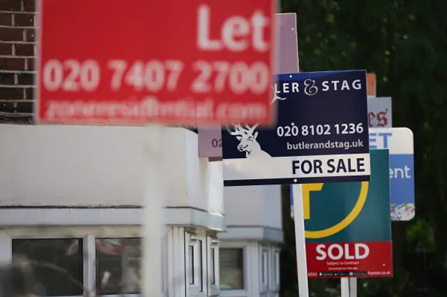 Estate agents placards are seen in front of houses in London