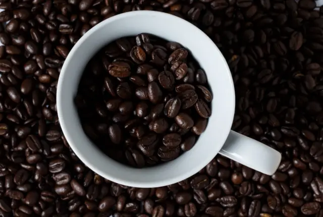 A coffee cup and coffee beans