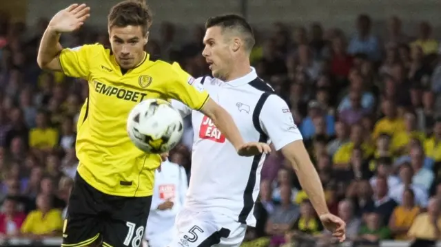 Burton Albion's Will Miller takes on Jason Shackell