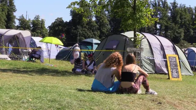 people next to a tent