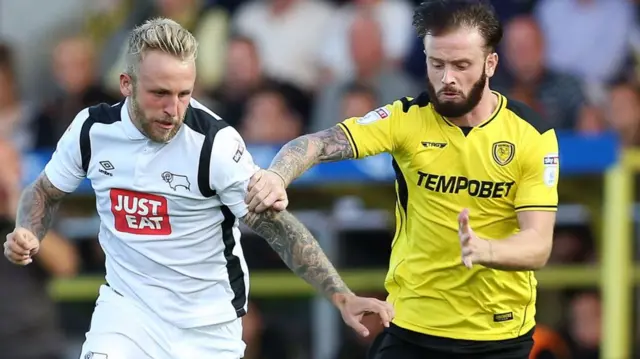 Johnny Russell, of Derby County, takes on Burton's John Brayford