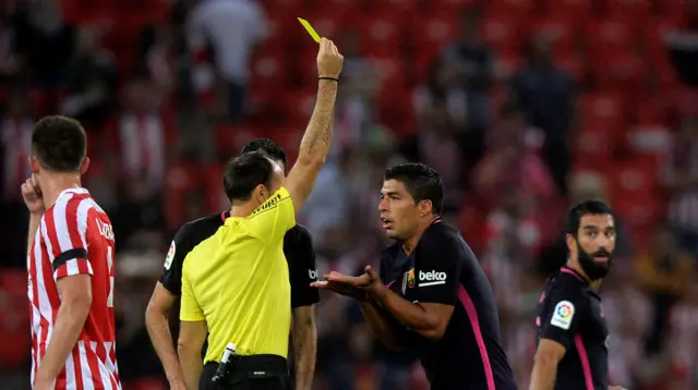 Barcelona's Luis Suarez receives a caution