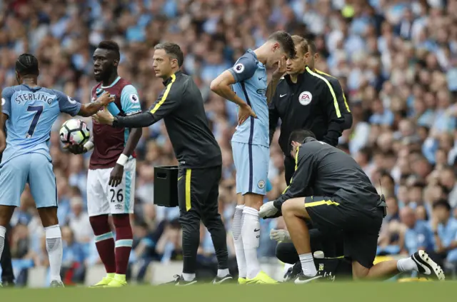 Man City's John Stones receives treatment