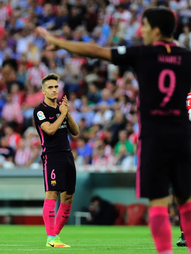 Denis Suarez looks over to Luis Suarez