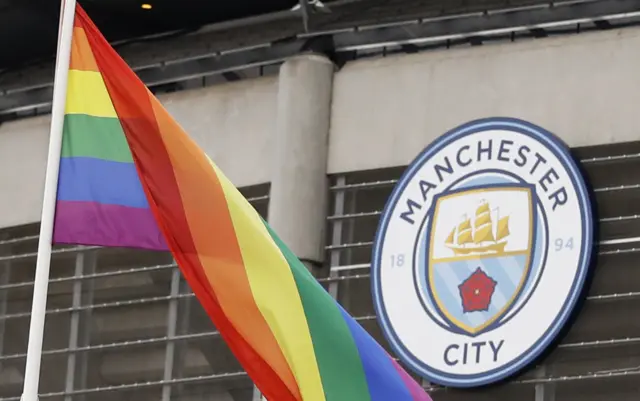 A rainbow flag flies outside the Eithad Stadium