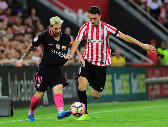 Barcelona's Lionel Messi battles with Athletic Bilbao's Aymeric Laporte