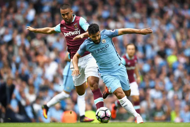 Sergio Aguero races away from West Ham defender Winston Reid