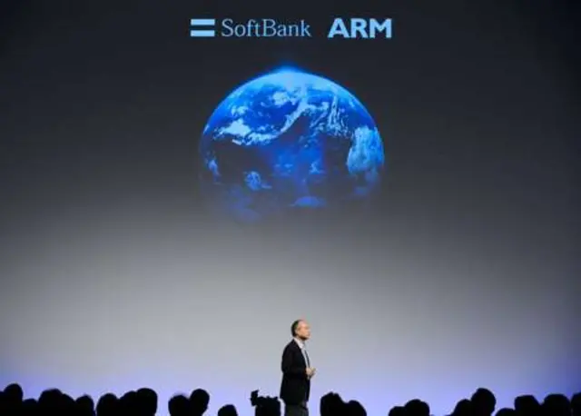 SoftBank chief executive Masayoshi Son stands on stage