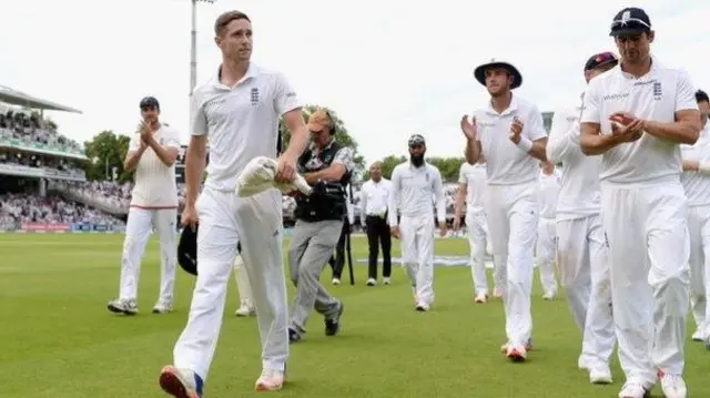 Chris Woakes leads his fellow England players off at Lord's