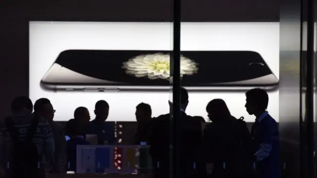 Apple iPhone projected onto wall in front of audience