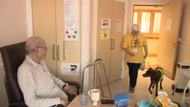 Joan and Coco visit patient in Bletchley