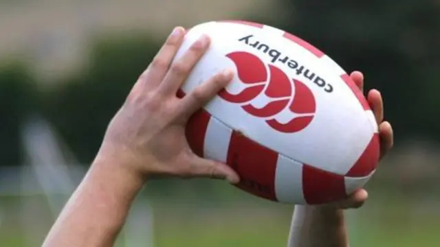 Man catching rugby ball