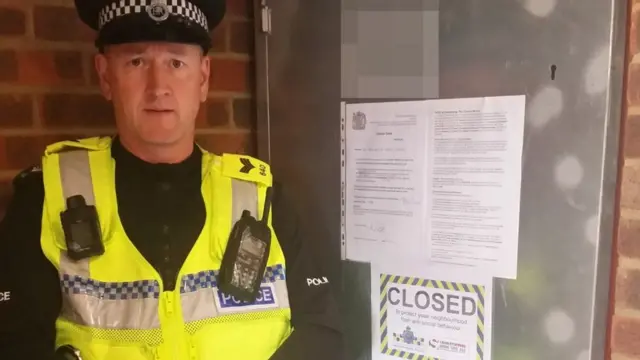 Policeman stands by notice on closed down drugs den