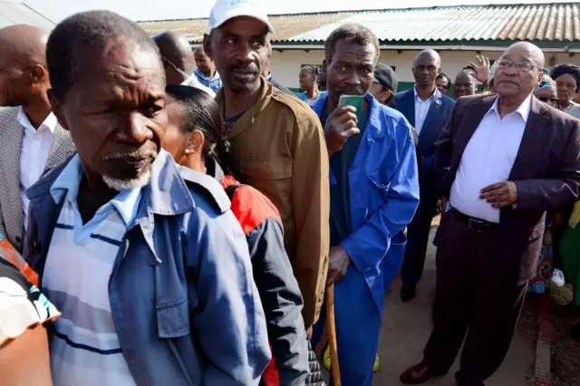 A handout photograph made available by the South African Government Communication and Information System (GCIS) shows President Jacob Zuma (R) waits to cast his vote at Ntolwane Primary School, during the municipal elections in Nkandla, KwaZulu Natal, South Africa, 03 August 2016.