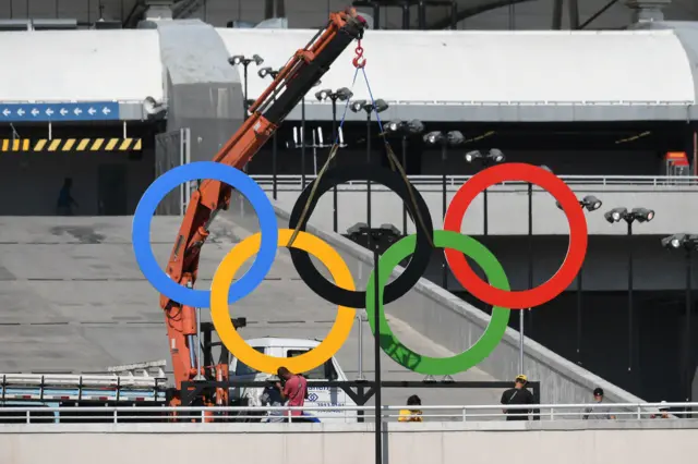 Olympic rings are put in place