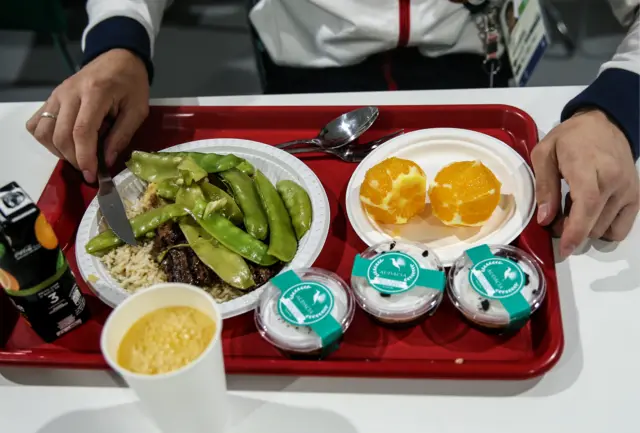 A Russian athlete eats his breakfast in the Olympic canteen