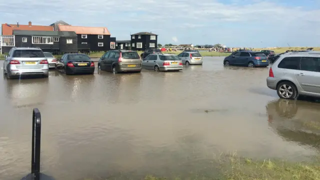 Cars in low level flooding in car park