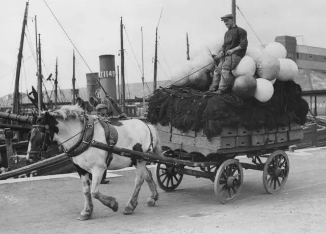 9th August 1934: A horse and cart arrives at Lowestoft to bring nets and 'buffs' for the fishing fleets leaving for the North Sea.