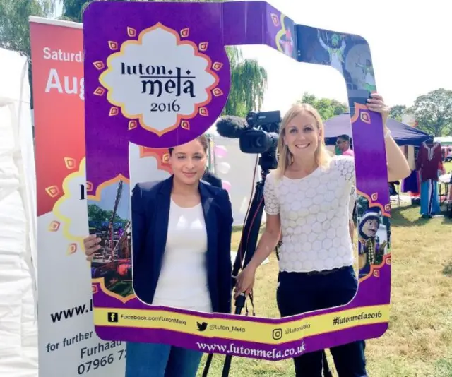 Reporter Kate Bradbrook with Luton Mela sign