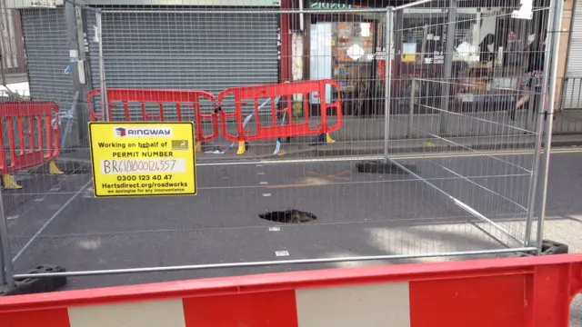 Hole in Vicarage Road, Watford, is surrounded by barriers
