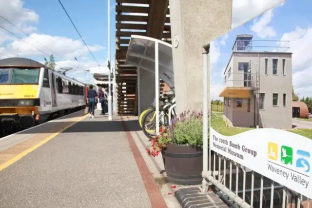 Diss railway station, showing platform, and a waiting train