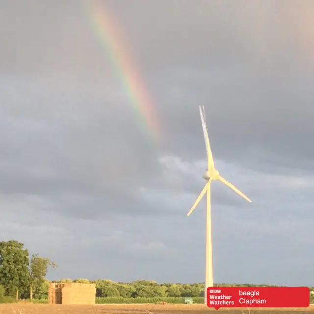 Rainbow over farmer's field and wind turbine in Clapham