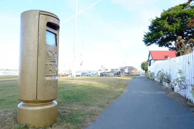 Gold postbox on Blackwater Estuary