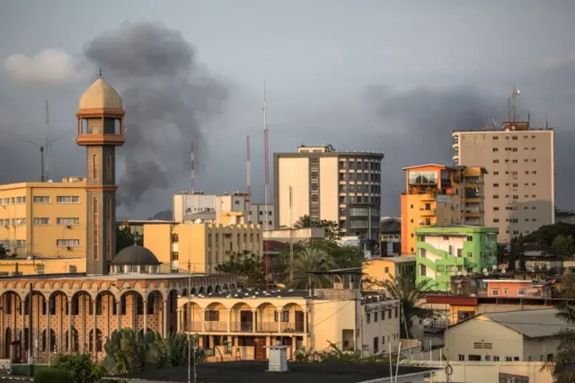 Smoke rises above the Libreville skyline