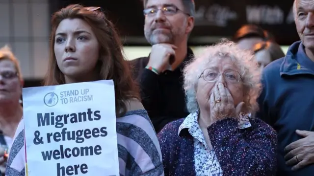 People with placards at vigil