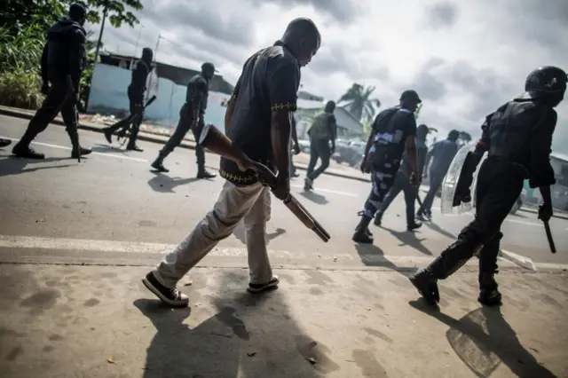 Police with guns and truncheons on patrol