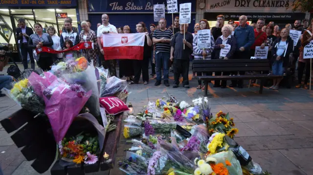 Flowers on a bench at vigil